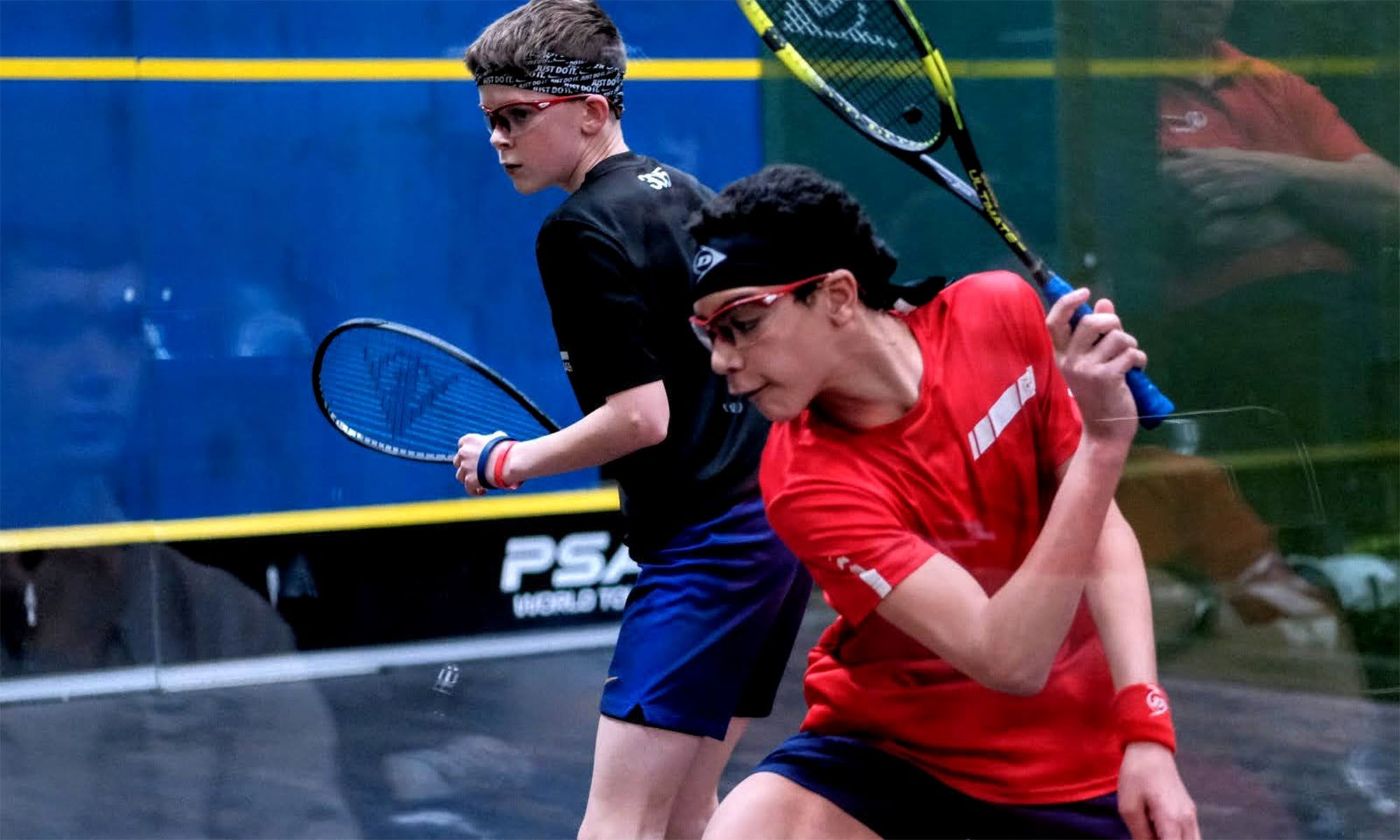 Two male squash players on court